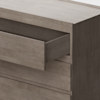 A close-up of a modern wooden dresser with a smooth finish, showing one drawer partially open and another drawer closed below it.