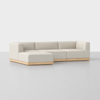 A modern L-shaped sectional sofa with light beige upholstery and a low wooden base, set against a plain white background.