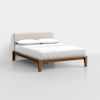 A modern bed with a light beige upholstered headboard, white bedding, and two pillows. The bed frame is made of wood with clean lines and a minimalist design, set against a plain white background.