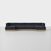 A modern, modular dark blue sectional sofa with low wooden base, arranged in an L-shape, placed on a light gray floor against a plain white background.