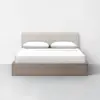 A bed with white sheets and pillows.