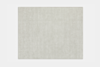 A rectangular, light beige area rug with a soft, solid color and subtle texture, displayed on a white background.