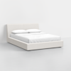 A modern, minimalist bed with a low-profile beige upholstered frame and headboard, dressed in white bedding and two pillows, set against a plain white background.