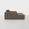 A side view of a modern, brown sectional sofa with plush cushions and a chaise lounge on the right side, set against a plain white background.