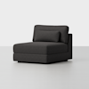 A modern, dark gray armless lounge chair with a wide seat, matching back cushion, and lumbar pillow, set against a plain white background.