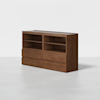 A modern wooden cabinet with a rich brown finish, featuring open shelves on the upper section and closed drawers on the lower section, set against a plain white background.