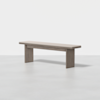 A minimalist wooden bench with a light beige cushioned seat and thick rectangular legs, set against a plain white background.