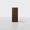 A tall, dark brown wooden cabinet is shown from the side against a plain white background. The cabinet has four visible drawers with simple, flat fronts and no visible handles.