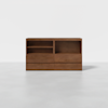 A modern, rectangular wooden cabinet with two open shelves on the left and two open spaces on the right, featuring four lower drawers. The cabinet sits on a plain white background.