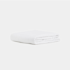 A neatly folded white blanket with a smooth, soft texture is placed against a plain white background.