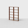 A wooden bookshelf with five shelves and two vertical dividers, standing empty against a plain white background.