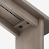 Close-up view of a wooden structure showing a joint where two beams meet, connected with screws and hardware, highlighting the craftsmanship and smooth wood texture.