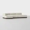 A modern, low-profile sectional sofa with light beige upholstery and a dark wooden base is set against a plain white background. The sofa has clean lines and a left-side chaise lounge.