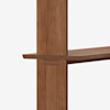 A close-up view of a wooden shelf slotting into a vertical wooden support, highlighting the joinery and natural wood grain against a plain white background.
