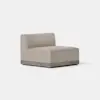 A modern, armless beige fabric chair with a low backrest and a wooden base, placed on a light grey floor against a plain white background.