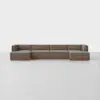 A modern, modular brown sectional sofa with wooden base, arranged in an L-shape against a plain white background on a smooth, light-colored floor.