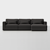 A modern dark gray sectional sofa with three seat cushions, matching back cushions, and an extended chaise lounge on the right side, set against a plain white background.