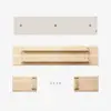 Four components of a light wood shelf, including a rectangular back panel, a long shelf piece, two end pieces, and five screws, laid out on a white background.