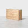 A light wood dresser with a minimalist design, featuring six wide drawers arranged in two columns of three, set against a plain white background.