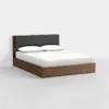 A modern wooden bed frame with a dark upholstered headboard, dressed in white bedding and two pillows, is set against a plain white background.