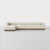 A modern, low-profile sectional sofa with cream-colored upholstery and a wooden base, arranged in an L-shape against a plain white background.