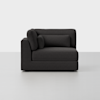 A modern dark gray sectional sofa with an armrest and backrest on the left side, featuring two cushions, set against a plain light gray background.