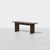 A minimalist dark wood bench with a rectangular seat and thick, slab-style legs, set against a plain white background.