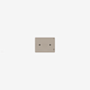 A beige rectangular electrical switch plate with two screw holes, mounted on a plain white wall.