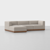 A modern beige sectional sofa with clean lines, low backrest, and wooden base, arranged in an L-shape on a plain light gray floor with a white background.