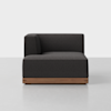A modern, dark gray upholstered corner sofa with a low wooden base, shown against a plain white background.