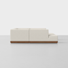 A modern off-white sectional sofa with a low wooden base, viewed from the side against a plain white background. The sofa has clean lines and a minimalist design.