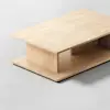 A minimalist light wood coffee table with clean lines, rectangular shape, and a lower shelf, placed on a smooth light gray surface.