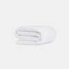 A neatly folded white comforter or duvet is placed on a plain white background.