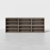 A large, rectangular, wooden shelving unit with three columns and three rows of open shelves, placed on a plain light-colored floor against a white background.