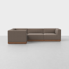 A modern L-shaped sectional sofa with brown upholstery and a wooden base, placed on a light gray floor against a plain white background.
