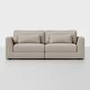 A modern, light beige upholstered sofa with square arms, two seat cushions, two back cushions, and two matching rectangular throw pillows, set against a plain white background.
