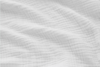 Close-up of soft, white, textured fabric with gentle folds and a subtle wavy pattern. The surface appears light and airy, with a slightly crinkled, quilted look.