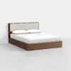 A modern wooden bed with a light beige upholstered headboard, shown with white bedding and pillows, set against a plain white background.