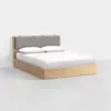 A modern wooden bed frame with a light wood finish, featuring a simple headboard with a cushioned gray panel and neatly made white bedding, set against a plain white background.