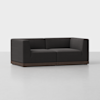 A modern, dark gray upholstered loveseat with a boxy design and low wooden base, set against a plain white background.