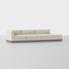 A modern, low-profile sectional sofa with light beige upholstery and a wooden base, set against a plain white background. The sofa has three seat sections and clean, minimalist lines.