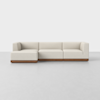 A modern, light beige L-shaped sectional sofa with a wooden base, set against a plain white background.