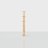 A tall, narrow wooden shelf unit with six evenly spaced shelves stands upright on a light, minimalist background.