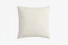 A square, off-white textured pillow is shown against a plain white background, viewed from above.