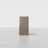 A tall, rectangular wooden cabinet with a light brown finish, viewed from the side against a plain white background. The cabinet has clean lines and a modern design.
