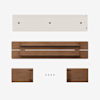 Top-down view of disassembled wooden furniture parts, including a long white panel, a long brown panel with a central opening, two smaller brown side pieces, and five black screws on a white background.