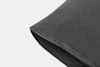 A close-up view of a dark gray pillowcase, neatly folded and placed on a plain white background.