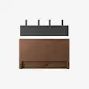 A minimalist image showing a wooden headboard below a dark gray, wall-mounted cushion pad with four black metal brackets, all against a plain white background.