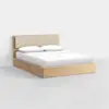 A modern wooden bed with a beige upholstered headboard, white bedding, and two pillows, set against a plain white background.
