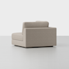 A modern, light gray upholstered sectional sofa piece with clean lines, viewed from an angle showing the back and one armrest, set against a plain white background.